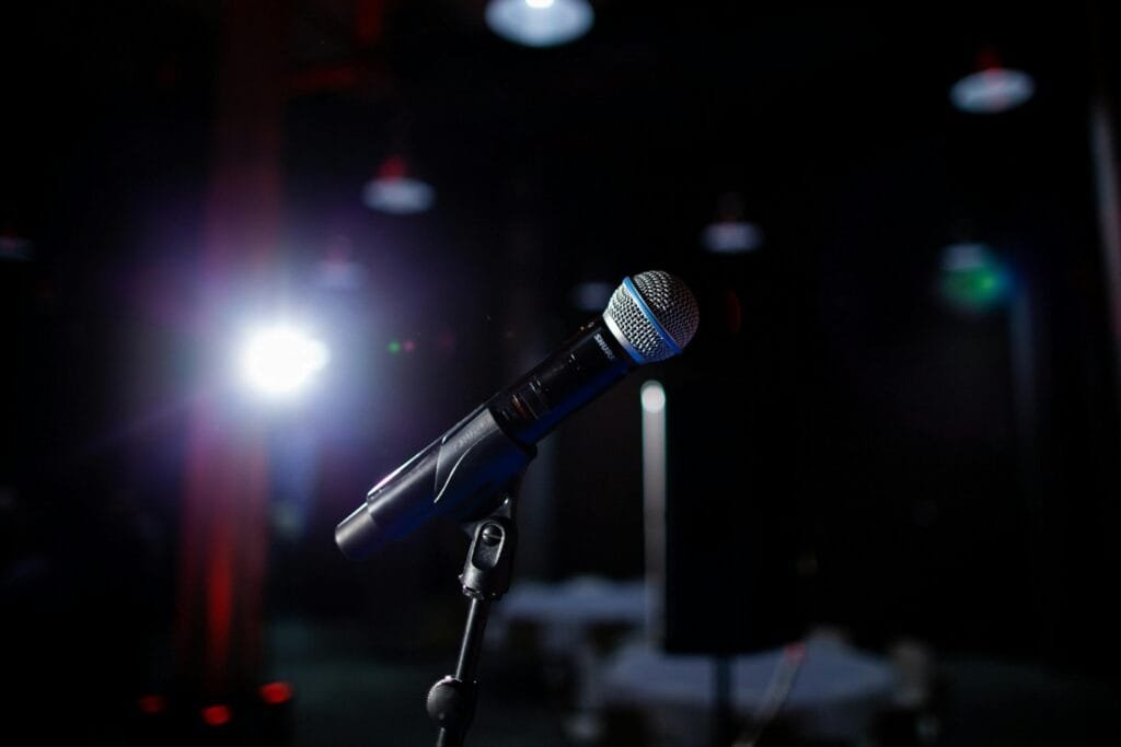 pexels-photo-2101487-2101487 Microphone on a stage with spotlight, perfect for performance and public speaking themes.