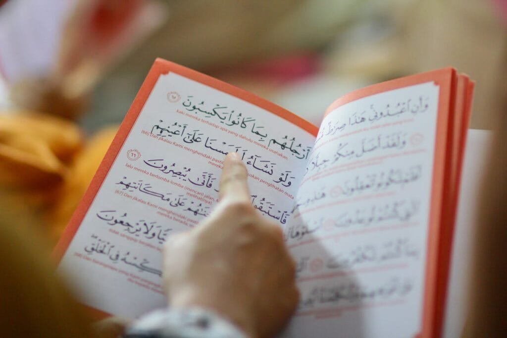 pexels-photo-921296 Close-up of a person reading an Arabic text, highlighting cultural education and learning.